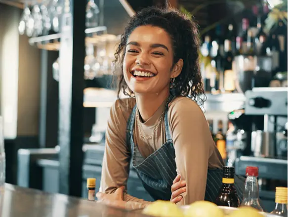 A smiling shop owner behind her counter