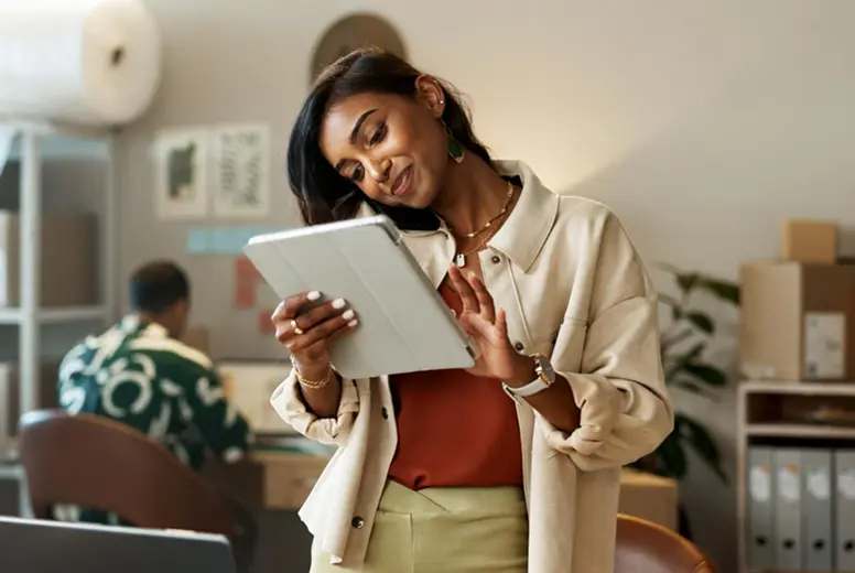 A studio owner managing inventory on a tablet