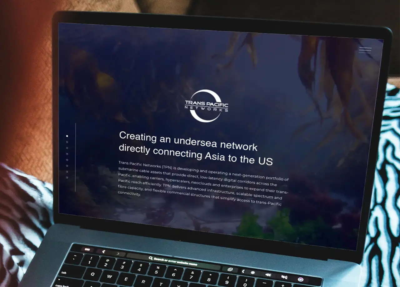 The Trans Pacific Networks website on a laptop